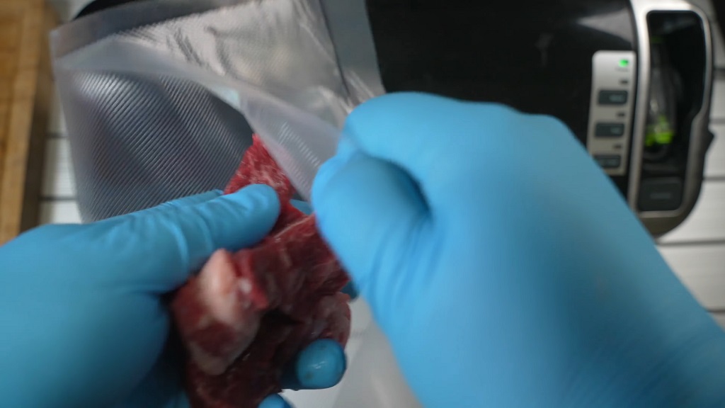 Packing meat in a vacuum bag